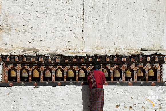 Buddhist Woman prays at a temple in Trongsa Dzong, Bhutan