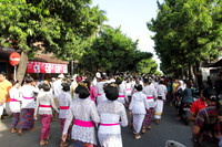 Traditionally dressed Balinese people walk as part of a temple procession