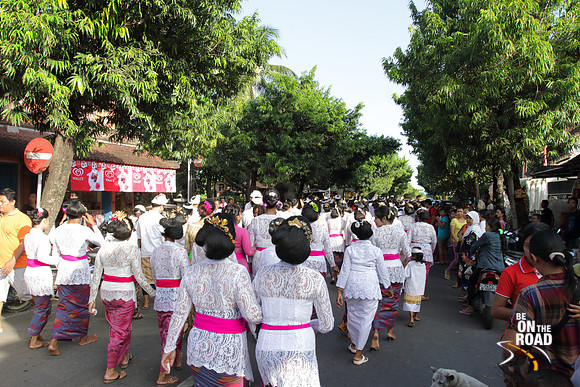 Traditionally dressed Balinese people walk as part of a temple procession