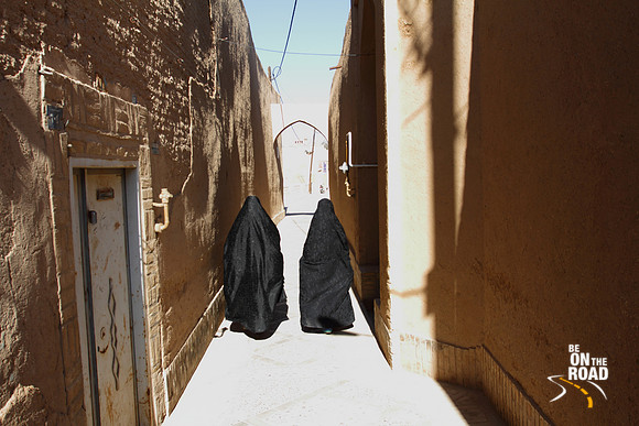 Muslim ladies walking through the narrow alleys of Yazd old town