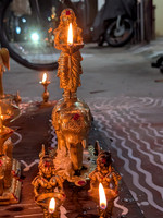 Lady on top of an elephant lamp being lit at Kallidaikurichi Sannadhi street