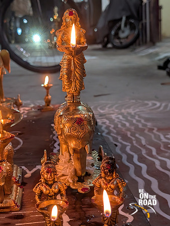 Lady on top of an elephant lamp being lit at Kallidaikurichi Sannadhi street