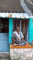 Local poses in front of his home at Thiruppudaimarudur Village