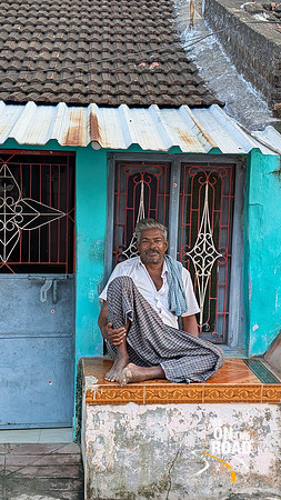 Local poses in front of his home at Thiruppudaimarudur Village