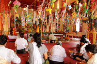 Prayers being offered inside Phra That Luang temple, Vientiane, Laos
