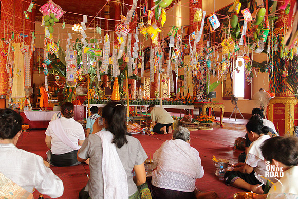 Prayers being offered inside Phra That Luang temple, Vientiane, Laos
