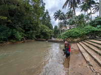 Devotees at the river behind the Aryankavu Saastha Temple, Kerala