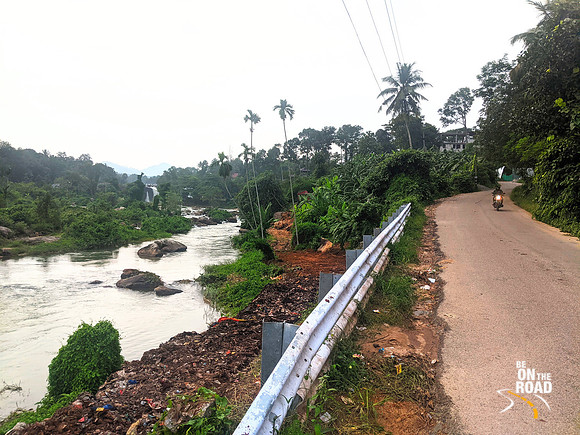 Thiruparappu Waterfalls seen in the yonder while traveling on this local village road