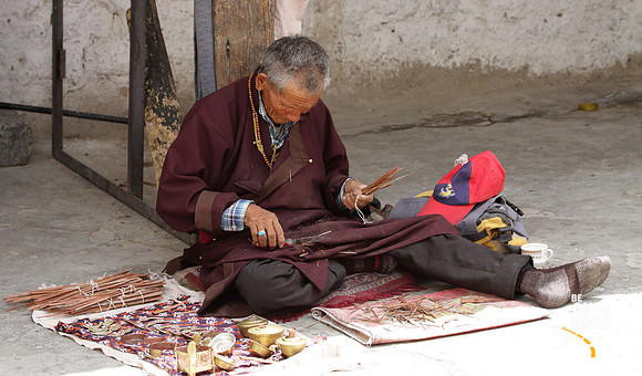 Local Ladakhi man selling incense stick and trinkets at Shey Palace, Ladakh, India
