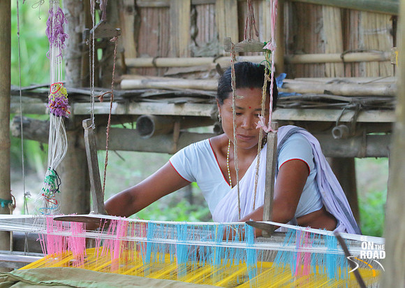 Portrait of Mishing tribal woman weaving on her traditional loom, Panbari village, Assam