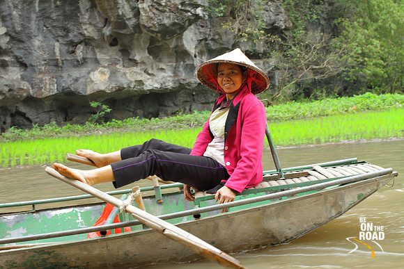 Vietnamese lady and her foot rowing boat at Tam Coc River, Ninh Binh, Vietnam