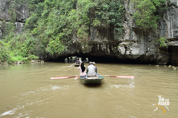 Getting ready to go under a limestone cave on Tam Coc river, Ninh Binh, Vietnam