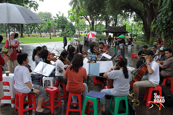 Learning to play musical instruments from street musicians at Taman Suropati, jakarta