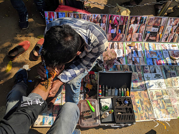 Tattoo artist in front of Udayagiri Caves, Odisha
