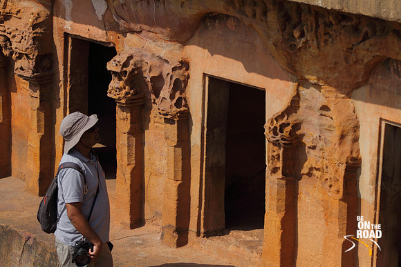 Admiring the sculptures on the walls of one of the oldest living cave temples of India, Odisha