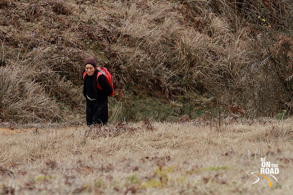 An elderly woman climbs the steep slopes of Dorjeeling village, Arunachal Pradesh