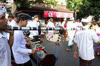 Balinese men play music during a procession at Ubud, Indonesia
