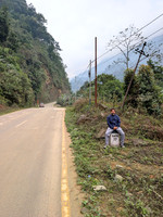 Sreedhar posing on a mile marker enroute Mechuka, Arunachal Pradesh