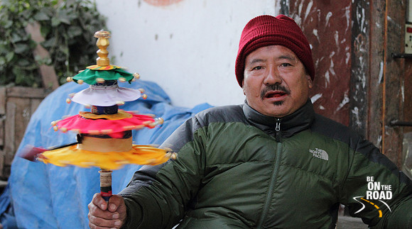 Local Trongsa Man with a colorful prayer wheel