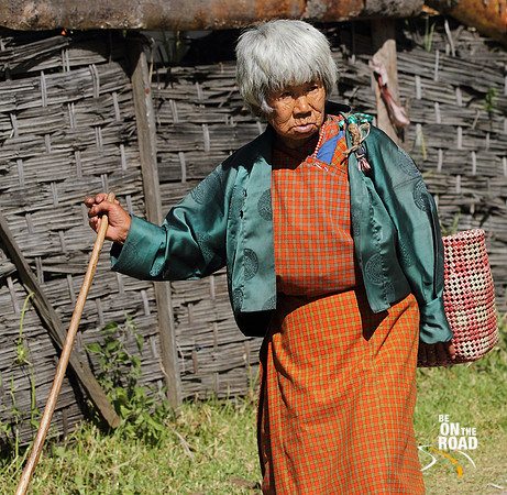An Elderly Bhutanese Woman walks in Trongsa, Bhutan