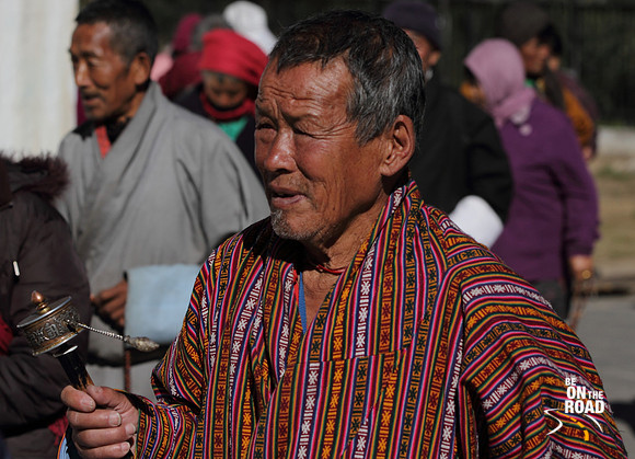 Bhutanese man and his prayer wheel at Thimphu, Bhutan