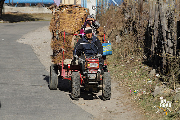A man and his family on a farm vehicle in Bumthang, Bhutan